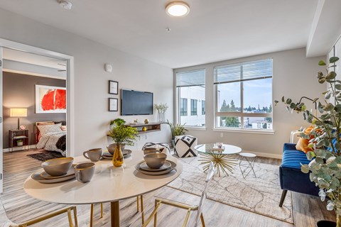 a living room with a table and chairs and a tv